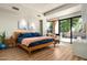 Bright and airy bedroom with a comfortable bed, stylish decor, and a private outdoor patio at 10687 E Fernwood Ln, Scottsdale, AZ 85262