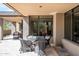 Covered patio featuring brick pillars, outdoor seating, and views of desert landscape at 10687 E Fernwood Ln, Scottsdale, AZ 85262