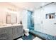 Luxurious bathroom featuring modern fixtures, marble walls, a glass-enclosed shower, and elegant vanity at 11215 N 37Th Ave, Phoenix, AZ 85029