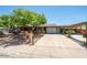 Charming single-story home with a beautiful mature tree in the front yard and an attached two-car garage at 11215 N 37Th Ave, Phoenix, AZ 85029