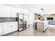 Open concept kitchen with stainless steel appliances, tiled backsplash, and a large island with seating at 11215 N 37Th Ave, Phoenix, AZ 85029