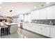 Elegant kitchen with white cabinetry, stainless steel appliances and a large central island at 11215 N 37Th Ave, Phoenix, AZ 85029