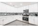 Bright kitchen showcasing white cabinets, stainless steel appliances, and stylish backsplash at 11215 N 37Th Ave, Phoenix, AZ 85029