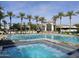 Community pool with a jacuzzi, lounge chairs, and a building in the background, perfect for recreation at 11947 E Terra Dr, Scottsdale, AZ 85259