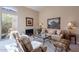 Cozy living room with neutral tones, a fireplace, and comfortable seating at 11947 E Terra Dr, Scottsdale, AZ 85259