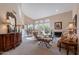 Bright living room featuring large windows, a fireplace, and elegant furnishings at 11947 E Terra Dr, Scottsdale, AZ 85259