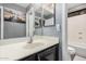 Bathroom features a large mirror over the sink and a shower/tub combination at 12818 W Pershing St, El Mirage, AZ 85335