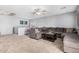 Cozy upstairs living room with large sectional and ceiling fan at 12818 W Pershing St, El Mirage, AZ 85335