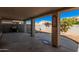 Covered patio area with BBQ and a desert landscaped backyard with block wall at 12818 W Pershing St, El Mirage, AZ 85335