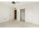 White bedroom featuring a fan, double closet, and a door to an additional closet at 13544 W Whitewood Dr, Sun City West, AZ 85375