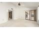 Bright main bedroom with ceiling fan and sliding glass door to the patio at 13544 W Whitewood Dr, Sun City West, AZ 85375