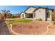 Large backyard features desert landscaping, grass, and a covered patio at 13615 W Merrell St, Avondale, AZ 85392