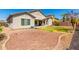 The house is a spacious backyard with desert landscaping, grass, covered patio at 13615 W Merrell St, Avondale, AZ 85392
