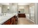 Spacious bathroom featuring double vanity, soaking tub, and tiled flooring at 13615 W Merrell St, Avondale, AZ 85392