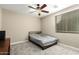 Bedroom with a cozy atmosphere, neutral walls, carpeted floor, and a window, ceiling fan at 13615 W Merrell St, Avondale, AZ 85392