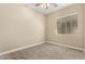 Cozy bedroom featuring neutral walls, plush carpet, and a window with natural light, ceiling fan at 13615 W Merrell St, Avondale, AZ 85392