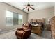 Relaxing bedroom features soft carpet, neutral walls, ceiling fan, and natural light at 13615 W Merrell St, Avondale, AZ 85392