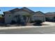 Inviting home showcasing a manicured lawn, mature trees, and a two-car garage at 13615 W Merrell St, Avondale, AZ 85392