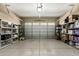 An organized two-car garage with ample shelving provides plenty of storage space for tools and equipment at 13615 W Merrell St, Avondale, AZ 85392