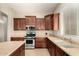 Well-lit kitchen with wooden cabinets, stainless steel appliances, and neutral countertops at 13615 W Merrell St, Avondale, AZ 85392