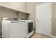 The laundry room features a side-by-side washer and dryer, with a storage shelf for detergents at 13615 W Merrell St, Avondale, AZ 85392