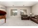 Inviting living room featuring plush carpeting, ample natural light, and a comfortable seating arrangement at 13615 W Merrell St, Avondale, AZ 85392