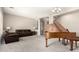 Spacious living room showcasing an open layout, neutral walls, soft carpet, and comfortable leather seating at 13615 W Merrell St, Avondale, AZ 85392