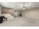 Open-concept living room with a staircase, neutral walls, plush carpet, and ample natural light at 13615 W Merrell St, Avondale, AZ 85392