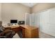This office features a built-in desk, neutral walls, and a spacious closet for storage and organization at 13615 W Merrell St, Avondale, AZ 85392
