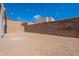 Large, empty backyard with a tall brick fence offering privacy and space for landscaping or recreation at 14445 N Valencia Dr, Fountain Hills, AZ 85268