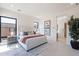 Bright bedroom featuring a luxurious bed, modern decor, and ample natural light from black framed windows at 14445 N Valencia Dr, Fountain Hills, AZ 85268