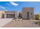 Stunning contemporary home featuring desert landscaping, a sleek garage door, and a stylish entrance at 14445 N Valencia Dr, Fountain Hills, AZ 85268