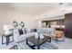 Spacious living area featuring modern furnishings, an open layout, and access to the kitchen and dining area at 14445 N Valencia Dr, Fountain Hills, AZ 85268