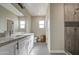 Modern bathroom with double vanity, granite countertops, and tiled shower at 14951 S Capistrano Rd, Arizona City, AZ 85123