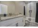 Well-lit bathroom with a shower-tub combo and a vanity with granite countertops at 14951 S Capistrano Rd, Arizona City, AZ 85123