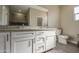 Bathroom featuring a double vanity with granite counters and modern hardware at 14951 S Capistrano Rd, Arizona City, AZ 85123