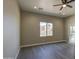 Bedroom features hardwood floors and a modern ceiling fan with an ensuite bathroom at 14951 S Capistrano Rd, Arizona City, AZ 85123