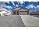 Charming single-story home featuring a two-car garage and low-maintenance gravel landscaping at 14951 S Capistrano Rd, Arizona City, AZ 85123