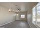 Bright living room with hardwood floors, ceiling fan, and backyard view at 14951 S Capistrano Rd, Arizona City, AZ 85123