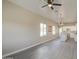 Bright, open-concept living room features modern ceiling fan and hardwood floors at 14951 S Capistrano Rd, Arizona City, AZ 85123