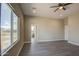 Bright living room with hardwood floors and a large window with a backyard view at 14951 S Capistrano Rd, Arizona City, AZ 85123