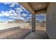 Covered patio overlooks a dirt backyard and block wall at 14951 S Capistrano Rd, Arizona City, AZ 85123