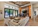 Spacious living room featuring high ceilings, a fireplace, a grand piano, and access to outdoor patio at 1527 W Caribbean Ln, Phoenix, AZ 85023