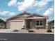 Charming single-story home with a neutral-toned exterior, a two-car garage, and a well-maintained gravel front yard at 15760 W Beryl Ave, Waddell, AZ 85355
