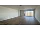Living room featuring a tile floor and sliding glass doors leading to the backyard at 15760 W Beryl Ave, Waddell, AZ 85355