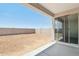 Covered patio overlooking a dirt backyard enclosed by a block fence at 15765 W Cheryl Dr, Waddell, AZ 85355