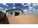 The home's backyard presents a dirt area between the house and the surrounding fence at 15765 W Cheryl Dr, Waddell, AZ 85355