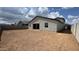 Large backyard featuring a dirt area awaiting landscaping, with a view of the home's exterior at 15765 W Cheryl Dr, Waddell, AZ 85355