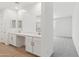 Bright bathroom featuring double sinks, quartz countertops and wood look flooring at 15765 W Cheryl Dr, Waddell, AZ 85355