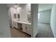 Stylish bathroom featuring a double sink vanity, large mirror, and shower at 15765 W Cheryl Dr, Waddell, AZ 85355